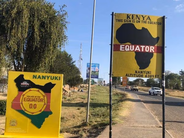 The Equator signs beside the road at Nanyuki